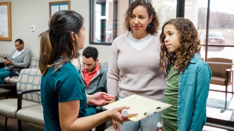 mother and daughter talking to healthcare provider about HPV vaccine